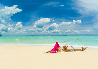 woman sunbathing lying down on the tropical beach