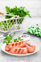 Grilled sausages on plate. BBQ sausages.