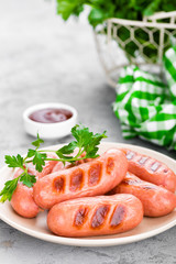 Grilled sausages on plate. BBQ sausages.