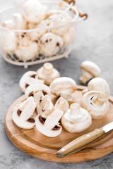 Fresh mushrooms. Raw mushrooms on wooden board. Champignons