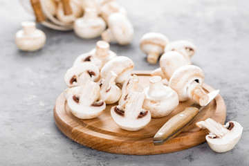 Fresh mushrooms. Raw mushrooms on wooden board. Champignons