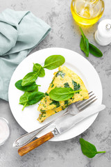 Omelet with spinach leaves. Omelette on plate, scrambled eggs