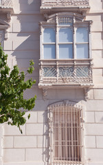 Vintage white balcony in Europe.Card from France. Decorative classical facade.