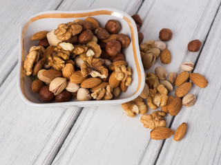Mix nuts in a plate on a white table