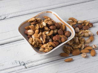 Mix nuts in a plate on a white table