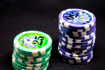 Two stacks of chips with different denominations, different colors on the gaming table.  Passion, game, poker, casino.
