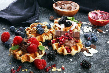 Belgian waffles with pomegranate and raspberries, homemade healthy breakfast with mint
