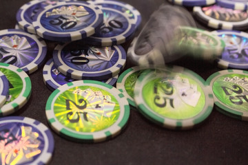Many game chips with different denominations, different colors on the gaming table.  Passion, game, poker, casino.