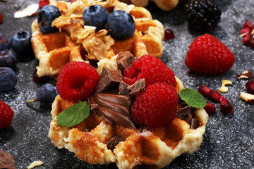 Belgian waffles with pomegranate and raspberries, homemade healthy breakfast with mint