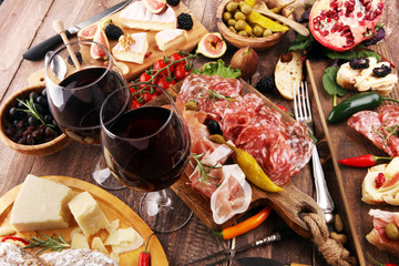 Italian antipasti wine snacks set. Cheese variety, Mediterranean olives, pickles, Prosciutto di...