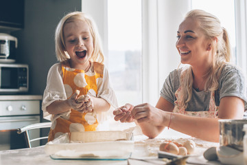 Mom cooking with daughter on the kitchen