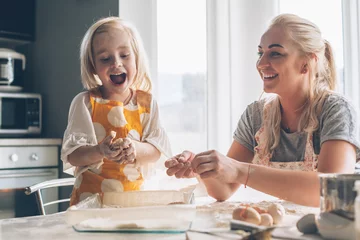 Photo sur Plexiglas Cuisinier Maman cuisine avec sa fille dans la cuisine