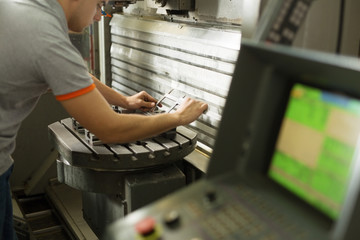 Metal Worker Taking Mesurements And CNC Machine