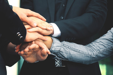 business people folding their hands together.concept of teamwork