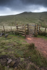 Footpath in Brecon Beacons landscape leading to Corn Du peak with dramatic sky overhead