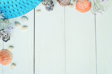 beach straw hat and seashells on a wooden background.photo with place for text