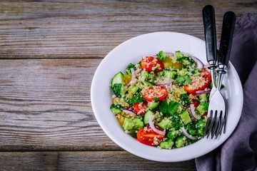 Quinoa Tabbouleh salad bowl with cucumbers, tomatoes, red onions and parsley