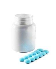 Medical blue pills and white bottle on white isolated background. Concept of healthcare and medicine.