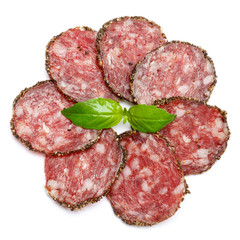 Dried organic salami sausage covered with pepper on white background