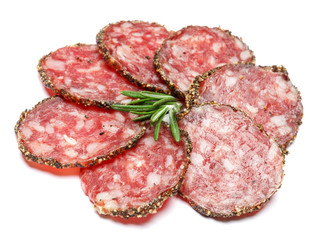 Dried organic salami sausage covered with pepper on white background