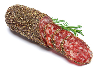 Dried organic salami sausage covered with pepper on white background