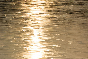 Frozen lake surface and sun reflection.