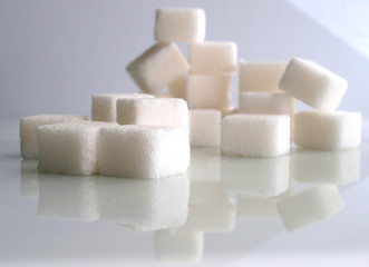sugar adiction: sugar cubes over white background..