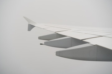 airplane wing during flight in heavy clouds