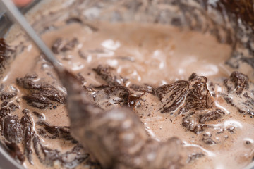 mixing cream into melted chocolate