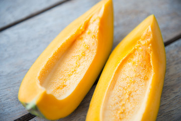 Yellow papaya fruit on wood table.