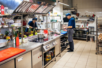 cooks prepare dishes for guests