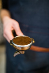 Espresso tamping.Barista is preparing ground for espresso machine.