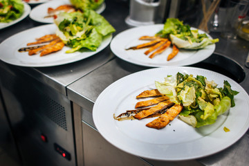 a dish of chicken meat and lettuce