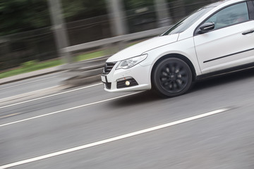 Fototapeta na wymiar Fast moving car on blurred background.