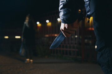crime concepts robbery concepts a robber aimed his sharp knife at a woman to rob her valuable...