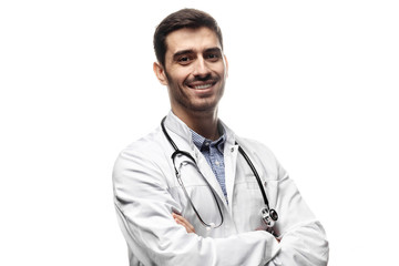 Smiling man doctor posing with arms crossed, wearing a stethoscope, isolated on white background