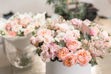 two beautiful bouquet of flowers set on wooden table. the work of the florist at a flower shop. A small family business