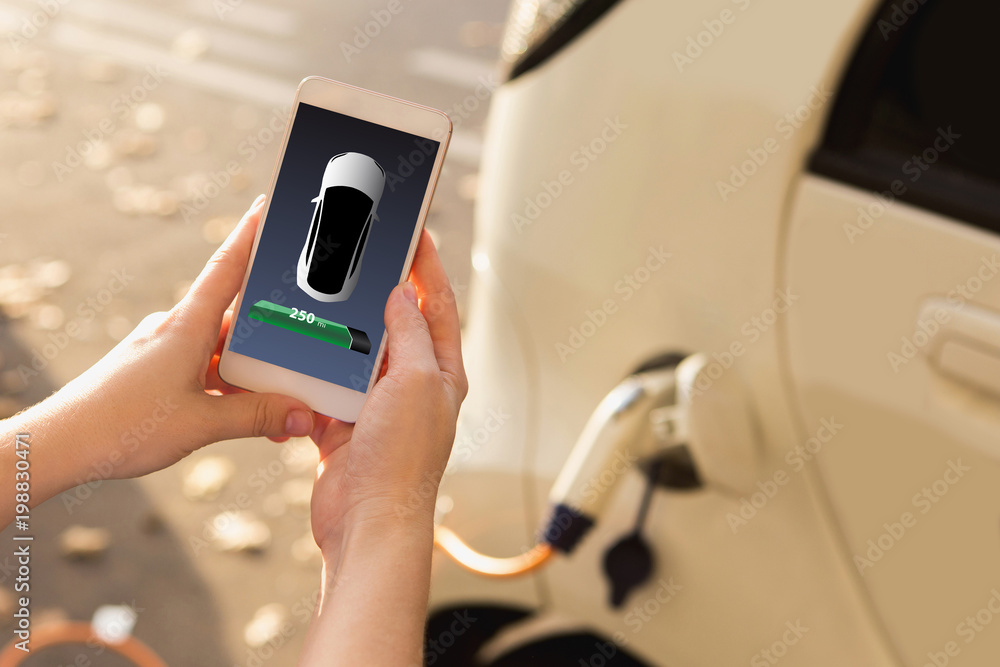 Poster hands with phone on a background of charging electric car. on a device screen indicator of power res