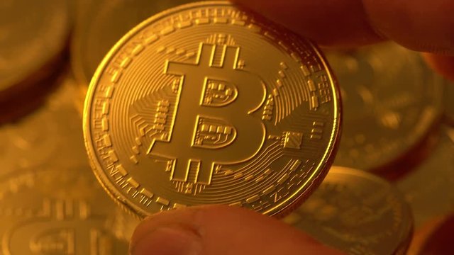 Coins golden bitcoin appear when mining on a video card. Animated 4K video.