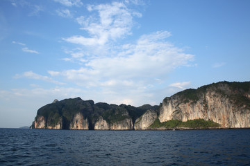 Fototapeta premium Rugged cliff lined coastline of Koh Phi Phi from the sea, Krabi province, Thailand.