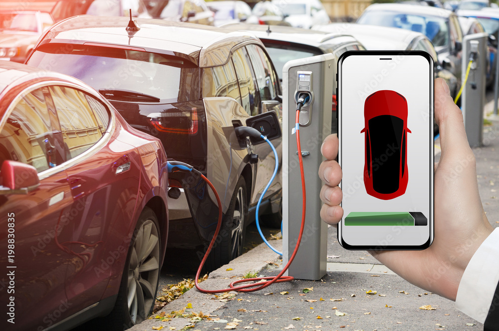 Poster hand with phone on a background of electric car charging point. on a device screen indicator of powe