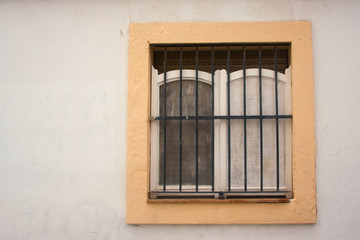 Window with iron bar grill in stone wall