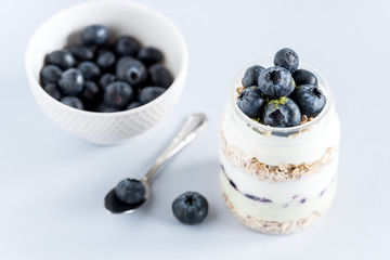 Serving of Yogurt with Whole Fresh Blueberries Oatmeal and Matcha Powder Healthy Diet Food Breakfast Above
