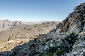 Windy gravel road through mountains im Oman