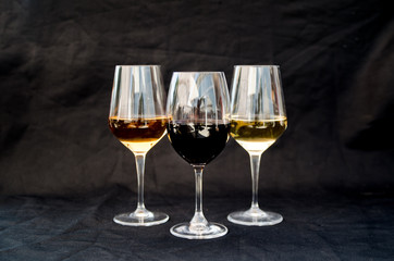 Three glasses of various wines