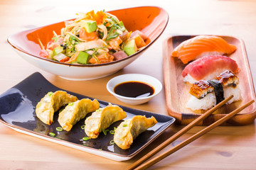 Japanese food combination, sushi nigiri, gyoza and crab salad