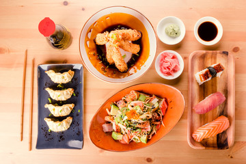 Japanese food combination, sushi nigiri, gyoza, crab salad and fried king prawns
