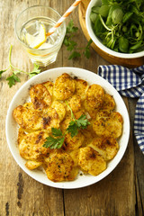 Homemade potato gratin with cheese and herbs