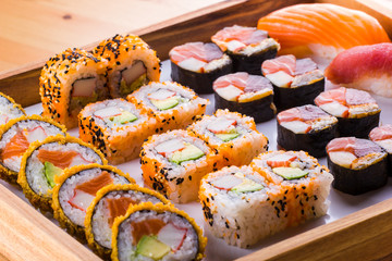Sushi Set nigiri and sushi rolls and on wooden serving board