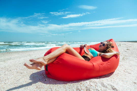Girl relaxing on lamzac on the beach